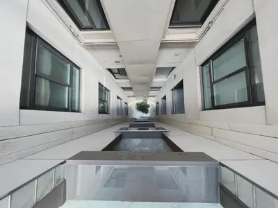 a hallway of an office building with a fountain at Stay U-nique Apartments Urquinaona II in Barcelona