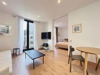 a living room with a bed and a table in a room at Stay U-nique Apartments Urquinaona II in Barcelona