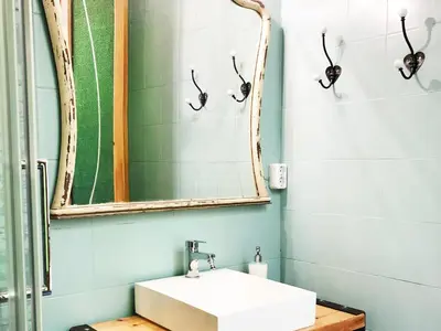 a bathroom with a sink and a mirror at Hostal Portugal in Barcelona