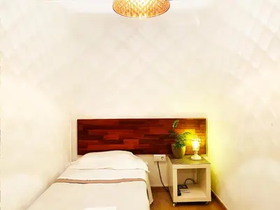 a bedroom with a bed and a night stand with a lamp at Hostal Portugal in Barcelona