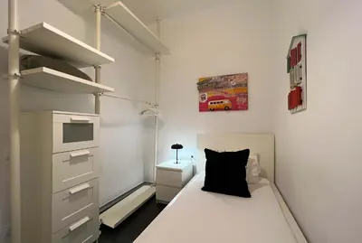 a small bedroom with a bed and a dresser at Stay Unique Apartments Cent in Barcelona