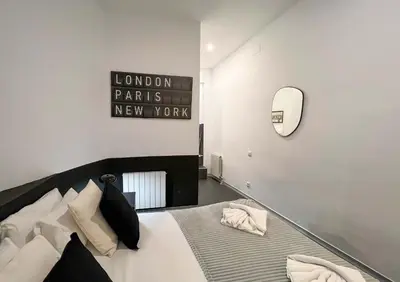 a bedroom with a bed with a sign on the wall at Stay Unique Apartments Cent in Barcelona