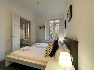 a bedroom with two beds and a lamp at Stay Unique Apartments Cent in Barcelona