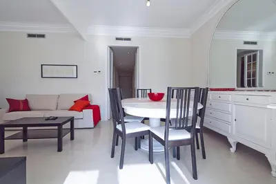 a living room with a table and chairs and a couch at Central and Spacious Family Apartment in Barcelona