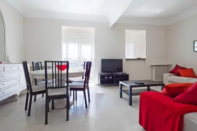 a living room with a table and a couch at Central and Spacious Family Apartment in Barcelona