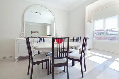 a dining room with a table and chairs and a mirror at Central and Spacious Family Apartment in Barcelona
