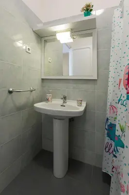 a bathroom with a sink and a mirror at Cozy Flat With Unbeatable Views to Sagrada Familia in Barcelona