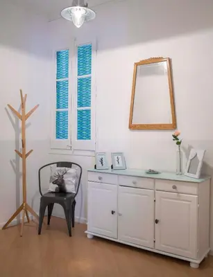 a white room with a mirror and a chair at Cozy Flat With Unbeatable Views to Sagrada Familia in Barcelona
