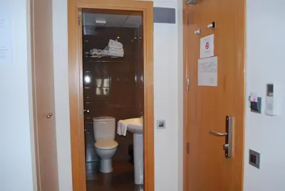 a bathroom with a toilet and a sink at Hostal Las Flores Ramblas in Barcelona