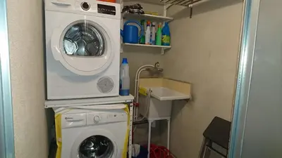 a washing machine and a washer in a small room at Cal Ton M in Castelltersol