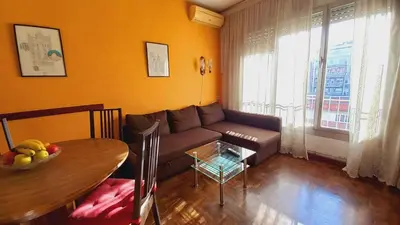 a living room with a couch and a table at Plaza Universitat in Barcelona