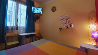 a bedroom with a bed and a tv on the wall at Plaza Universitat in Barcelona