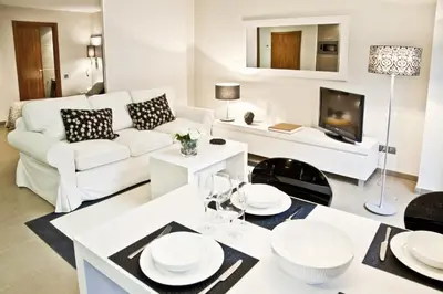 a living room with a white couch and a table at Up Suites BCN in Barcelona