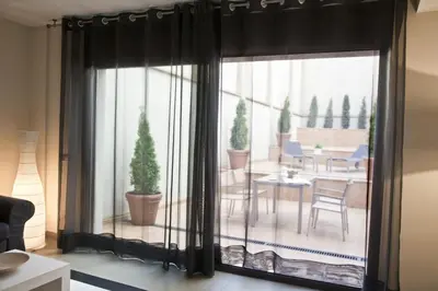 a room with a large window with a table and chairs at Up Suites BCN in Barcelona