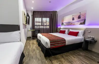 a hotel room with two beds and purple lighting at Leonardo Boutique Hotel Barcelona Sagrada Familia in Barcelona
