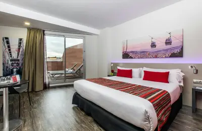 a hotel room with a large bed with red pillows at Leonardo Boutique Hotel Barcelona Sagrada Familia in Barcelona