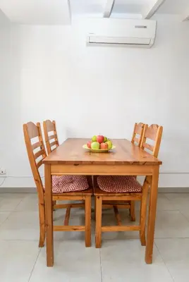 a wooden table with two chairs and a bowl of fruit at Private Roof Top Sant Antoni in Barcelona