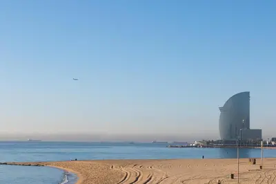 a view of a beach with buildings in the background at Private Roof Top Sant Antoni in Barcelona