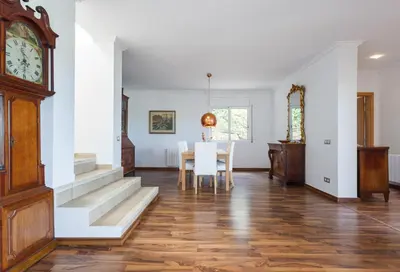 a dining room with a table and a clock at HHBCN Can Surià in Olivella