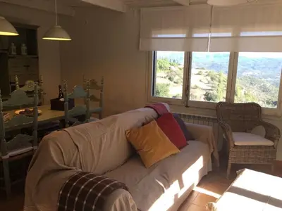 a living room with a couch and a window at Montserrat La Calsina in Monistrol