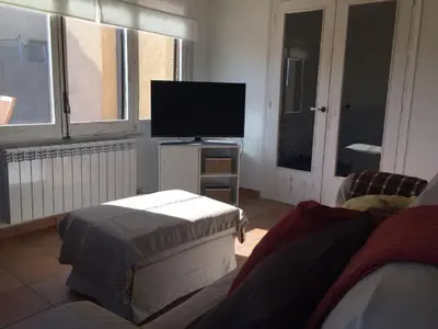 a living room with a tv and a couch at Montserrat La Calsina in Monistrol
