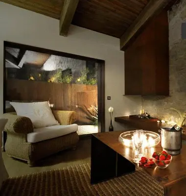 a living room with a chair and a table in a room at Fonda La Masia Del Sola in Monistrol de Calders