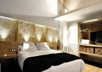 a bedroom with a large bed and a television at Fonda La Masia Del Sola in Monistrol de Calders