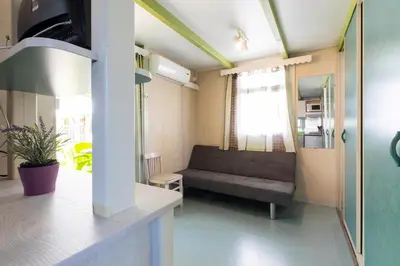 a living room with a couch and a table at Camping Bungalows El Far in Calella