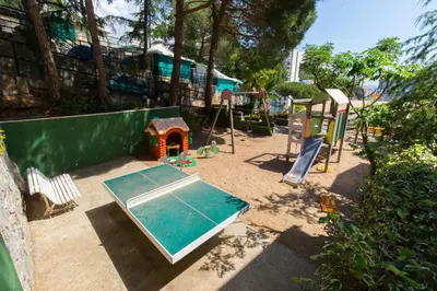 a playground with a slide and a play structure at Camping Bungalows El Far in Calella