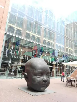 a statue of a head in front of a building at Hostal del Palau in Barcelona