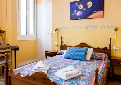 a bedroom with a bed with towels on it at Hostal del Palau in Barcelona