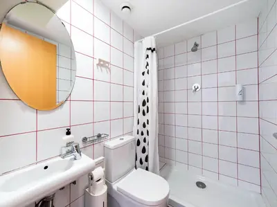 a bathroom with a toilet and a sink and a mirror at Hostal Athenas in Sant Adria de Besos