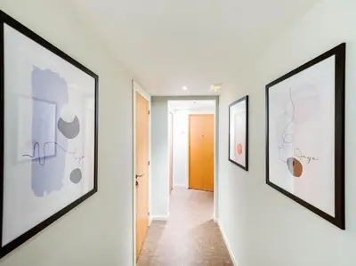 a hallway with three framed art on the walls at Hostal Athenas in Sant Adria de Besos