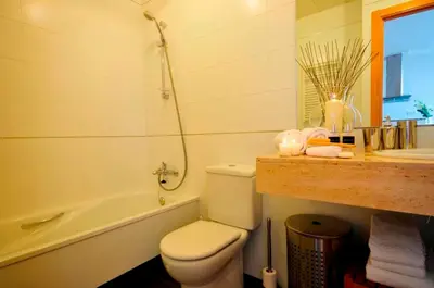 a bathroom with a toilet and a tub and a sink at Tendency Apartments 3 in Barcelona