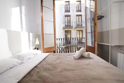 a bedroom with a large bed with a large window at Hostal Hera in Barcelona