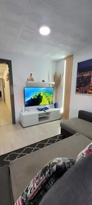 a living room with a large aquarium in the wall at APARTAMENTS B O D CoLLBLANC in Hospitalet de Llobregat