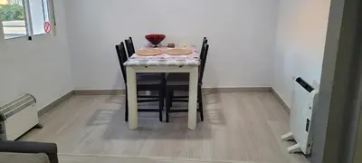 a table with chairs and a table with cookies on it at APARTAMENTS B O D CoLLBLANC in Hospitalet de Llobregat