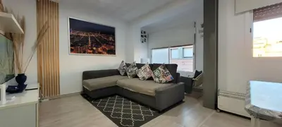 a living room with a couch and a window at APARTAMENTS B O D CoLLBLANC in Hospitalet de Llobregat