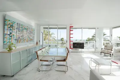 a living room with a glass table and chairs at You Stylish Beach Apartments in Barcelona