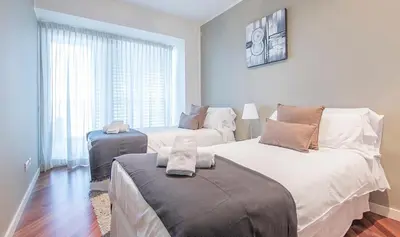 a bedroom with two beds and a window at You Stylish Beach Apartments in Barcelona