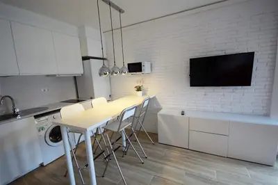 a kitchen with a table and chairs in a room at Apartamento Playa Mar in Castelldefels