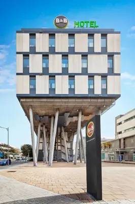 a hotel building with a sign on top of it at B&B HOTEL Barcelona Mataro in Mataró