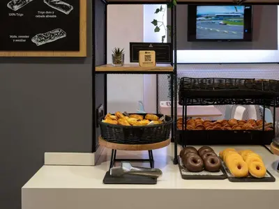 a table with many different types of food on it at Ibis Montmelo Granollers in Granollers