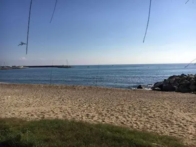 a sandy beach with the ocean in the background at Nice and quiet flat in Premià de Mar - HUTB 01790 in Premiá de Mar