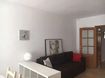 a living room with a black couch and a table at Nice and quiet flat in Premià de Mar - HUTB 01790 in Premiá de Mar