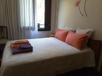 a bedroom with a bed with red pillows and a window at Apartamento Gran Via de les Corts Catalanes in Barcelona