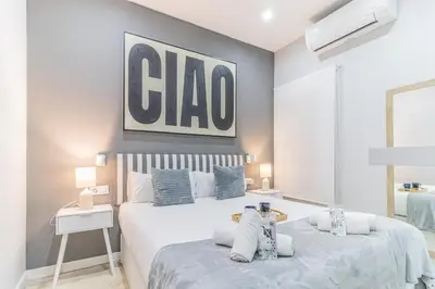 a bedroom with two beds and a cda sign on the wall at Fira Rooms Barcelona Hospitalet in Hospitalet de Llobregat