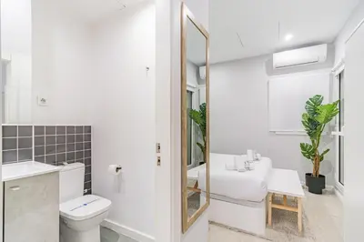 a bathroom with a toilet sink and a mirror at Fira Rooms Barcelona Hospitalet in Hospitalet de Llobregat