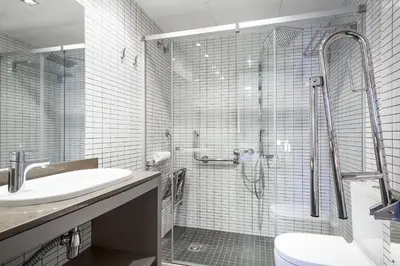 a bathroom with a shower and a sink and a toilet at Hotel Acta Laumon in Barcelona