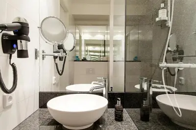 a shower in a bathroom with a bottle of soap at Motel One Barcelona-Ciutadella in Barcelona